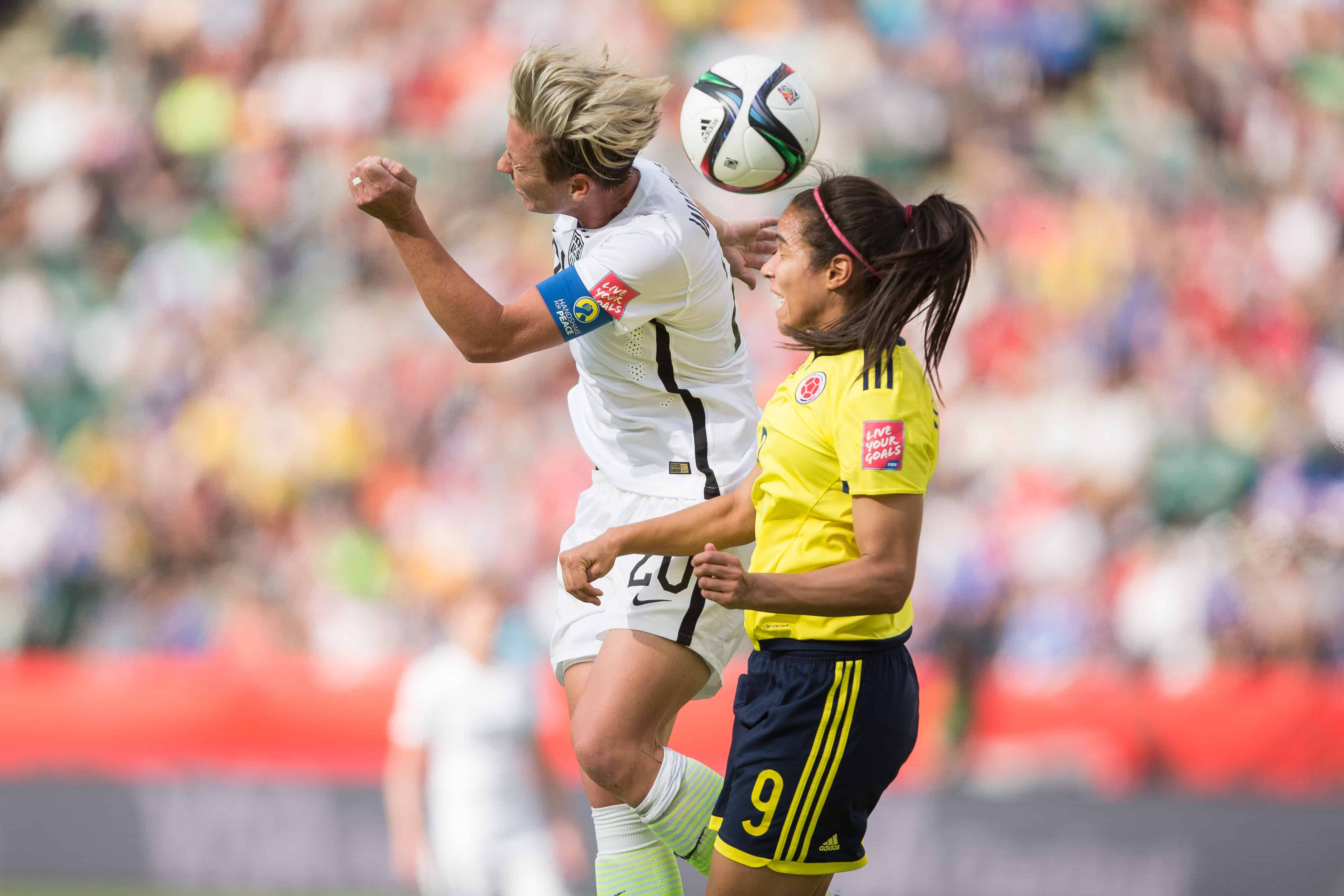 USA's Abby Wambach, left, and Colombia's Orianica Velasquez jump for the ball.