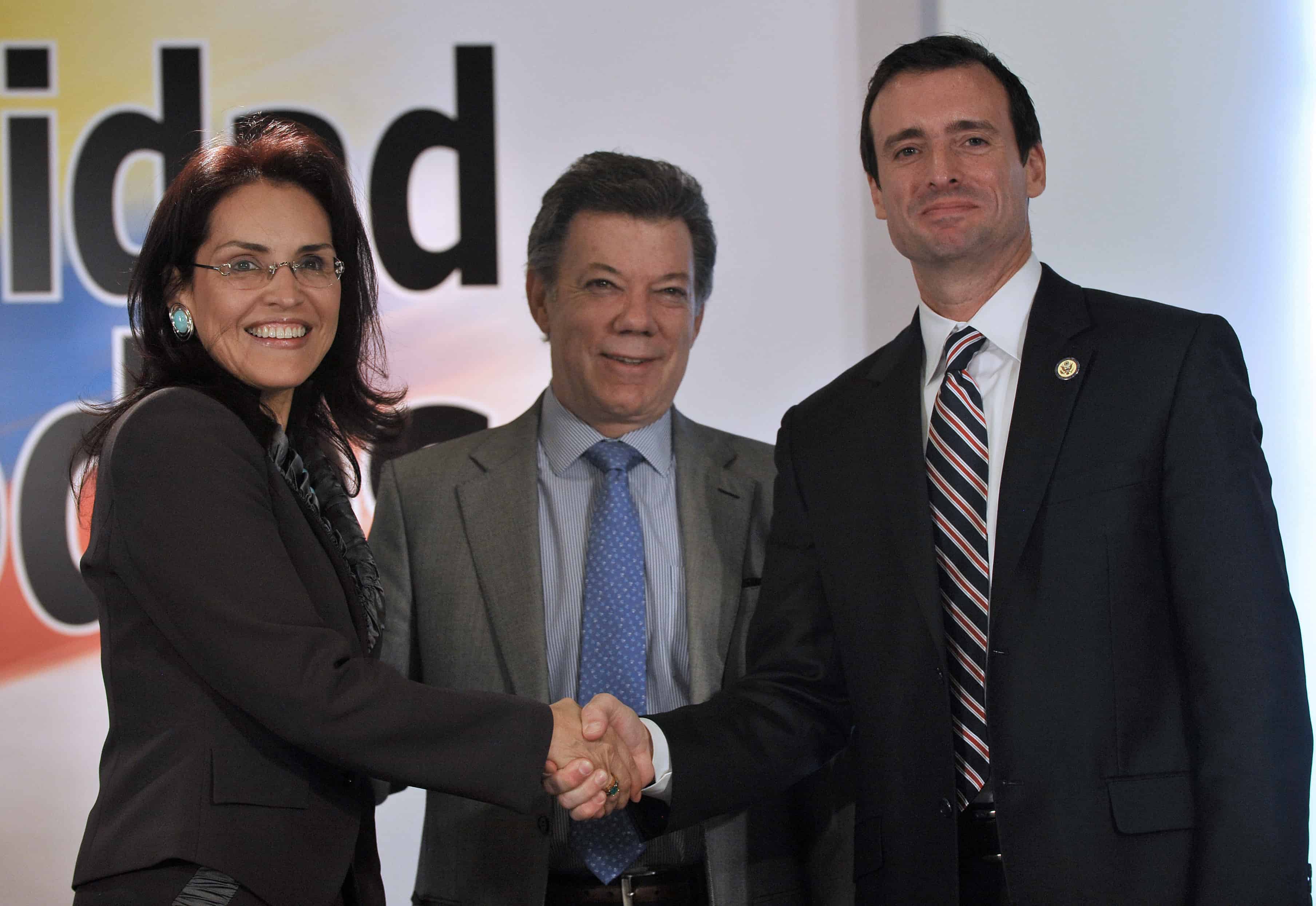 In this 2011 file photo, Colombia's President Juan Manuel Santos, center, shakes hands with Colombia's Attorney General Viviane Morales and U.S. Attorney for the Southern District of Florida Wifredo Ferrer.