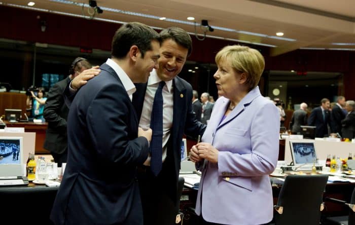 German Chancellor Angela Merkel, right, speaks with Greek Prime Minister Alexis Tsipras, left, and Italian Prime Minister Matteo Renzi.