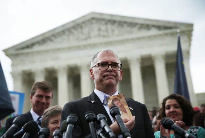 Plaintiff Jim Obergefell holds a photo of his late husband John Arthur.