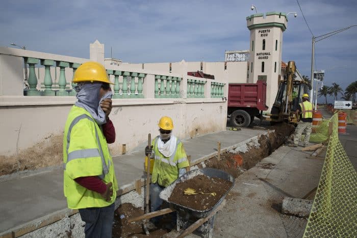 Construction workers make repairs to a street in Old San Juan, Puerto Rico.