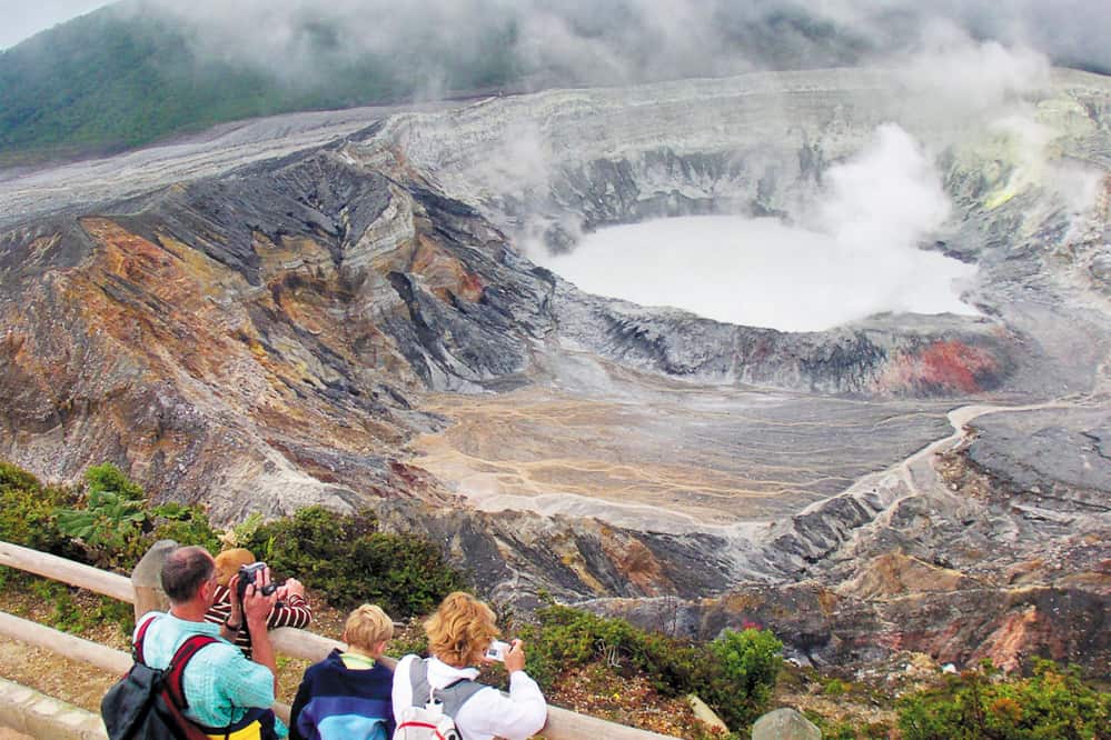 Visitors to Poás Volcano National Park's crater overlook.