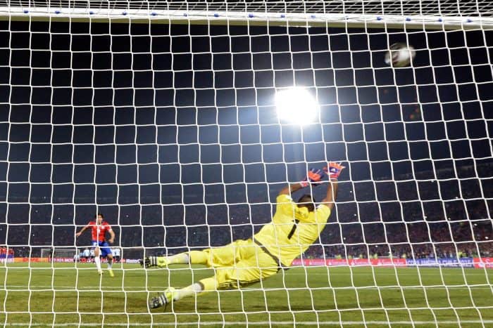 Chile's midfielder Matias Fernandez scores against Argentina during the penalty shootout of the 2015 Copa America football championship.
