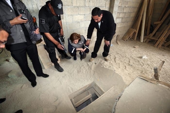 Mexico's Attorney General, Arely Gómez (second from right), looks at the alleged end of the tunnel through which Mexican drug lord Joaquín “El Chapo” Guzmán could have escaped from the Altiplano prison, at a house in Almoloya de Juárez, Mexico, on July 12, 2015.