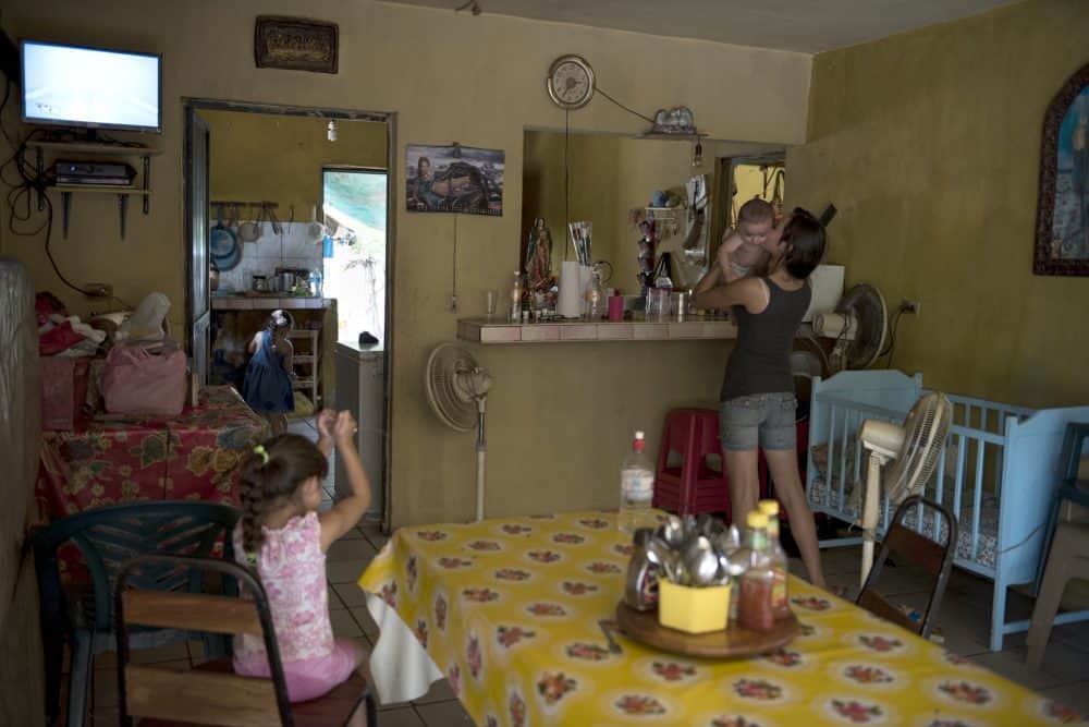A girl holds her baby cousin at her family's restaurant on in Santiago De Los Caballeros, Mexico. This area is a base of operations for El Chapo's Sinaloa cartel and his support among the locals, combined with the area's rugged terrain, will make capturing him a challenge should he choose to return to the area, July 17, 2015.