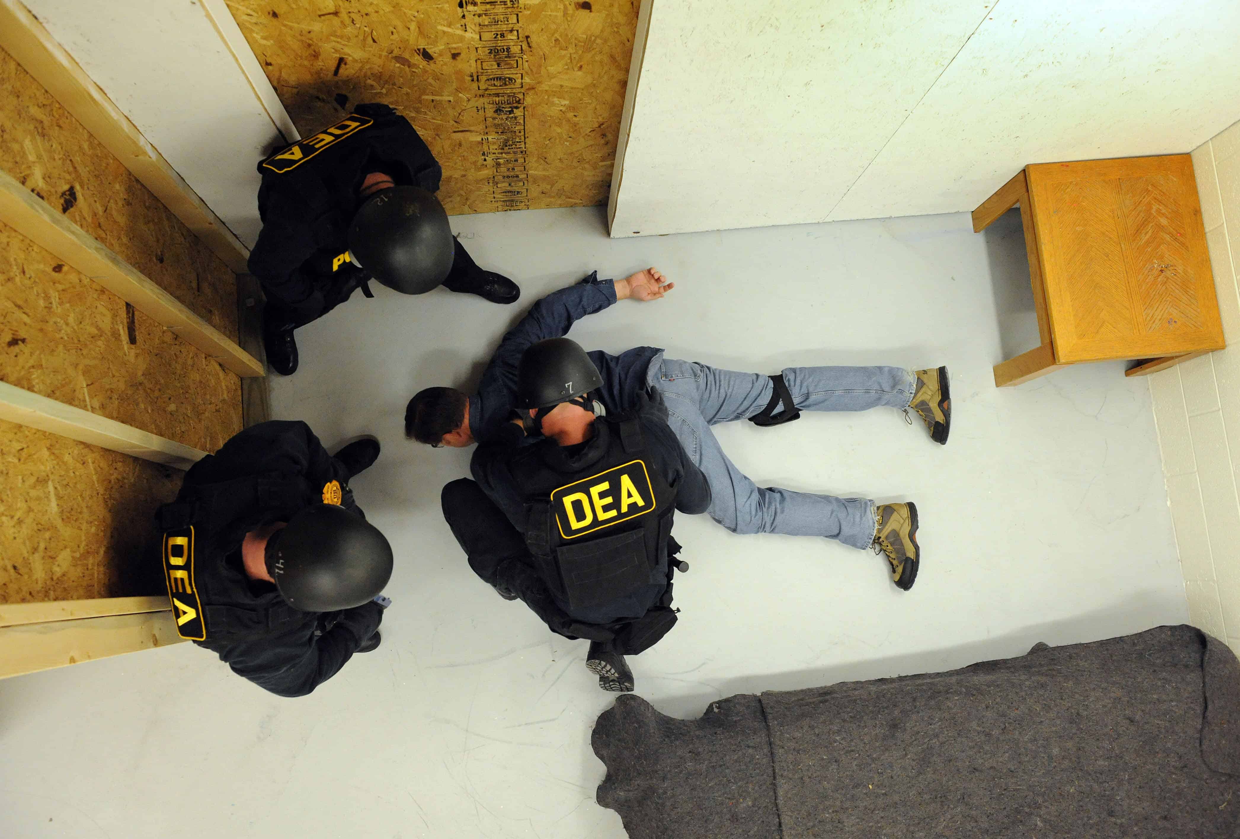 U.S. Drug Enforcement Administration (DEA) Agents simulate a raid.