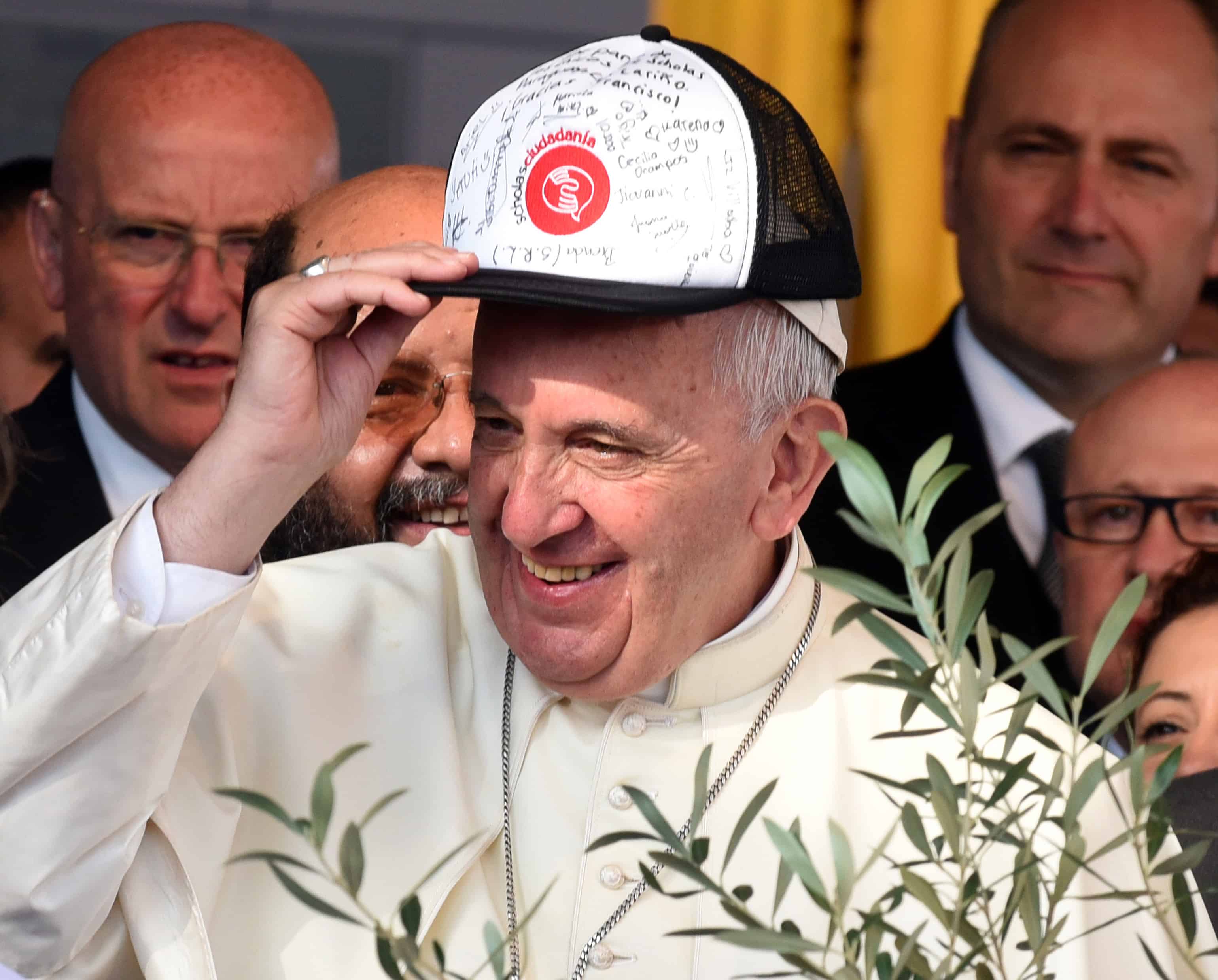 Pope Francis wears a cap signed by residents of Bañado Norte during his visit in Asunción.