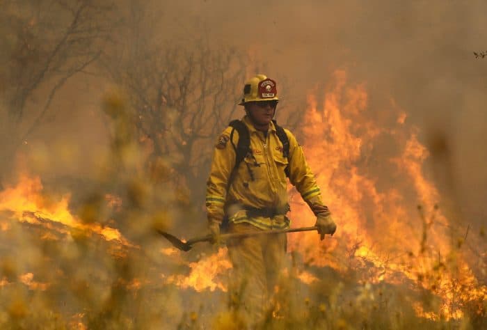 Cal Fire firefighter Johnny Miller monitors flames from the Rocky Fire.