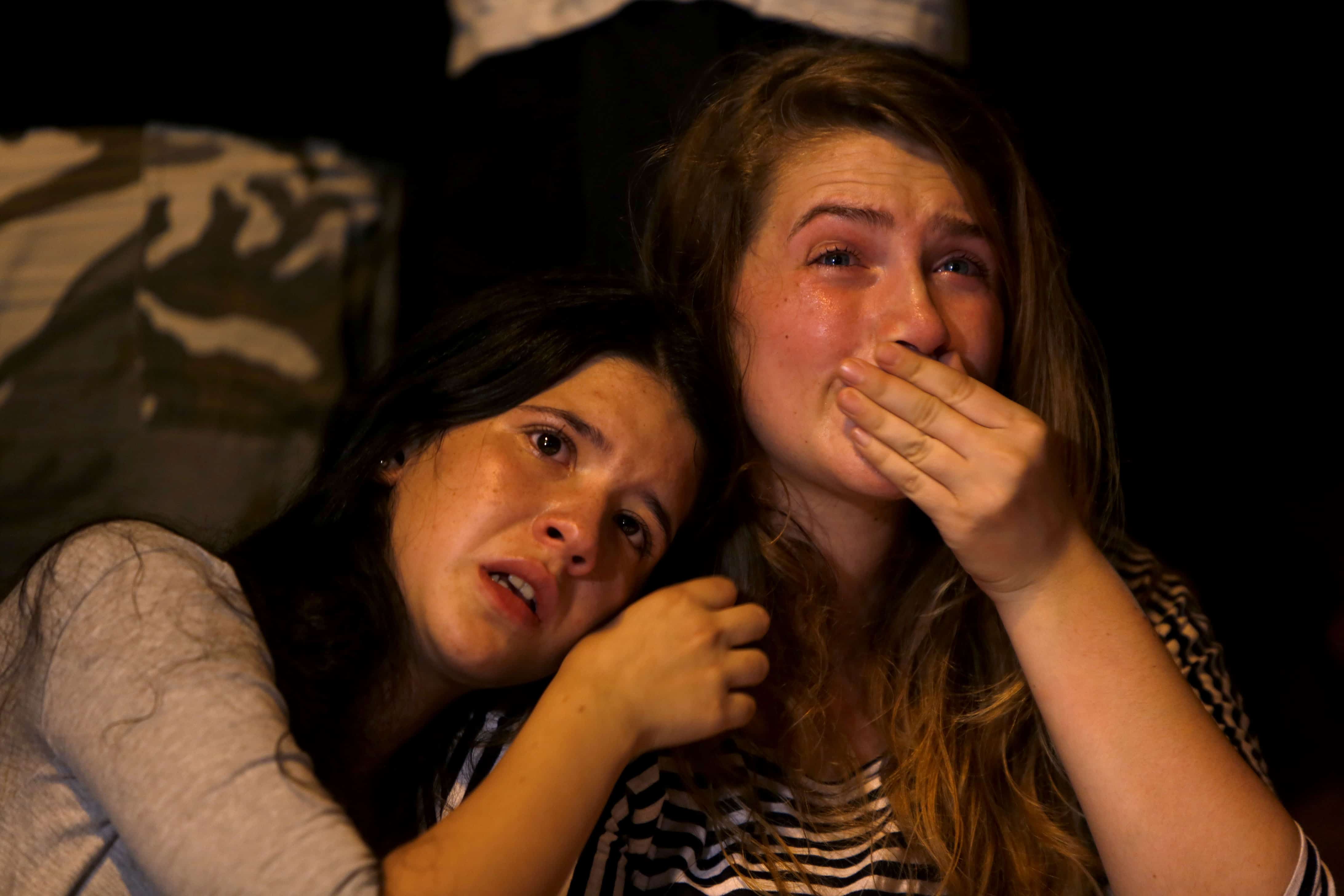 Israeli girls cry during a gathering of hundreds of friends, classmates, teachers, members of the gay community and supporters in downtown Jerusalem.