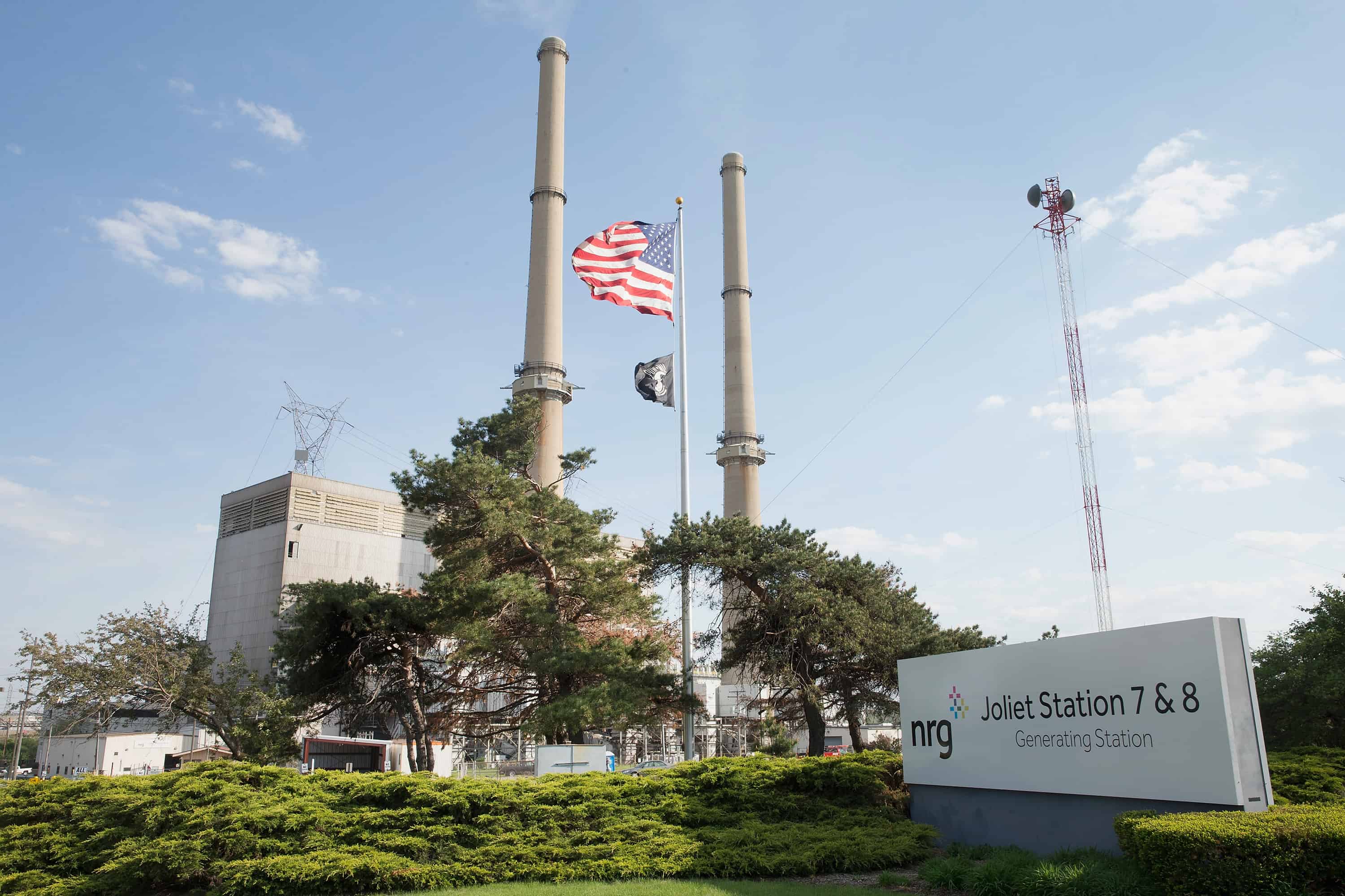 A U.S. flag hangs in front of NRG Energy's Joliet Station power plant.
