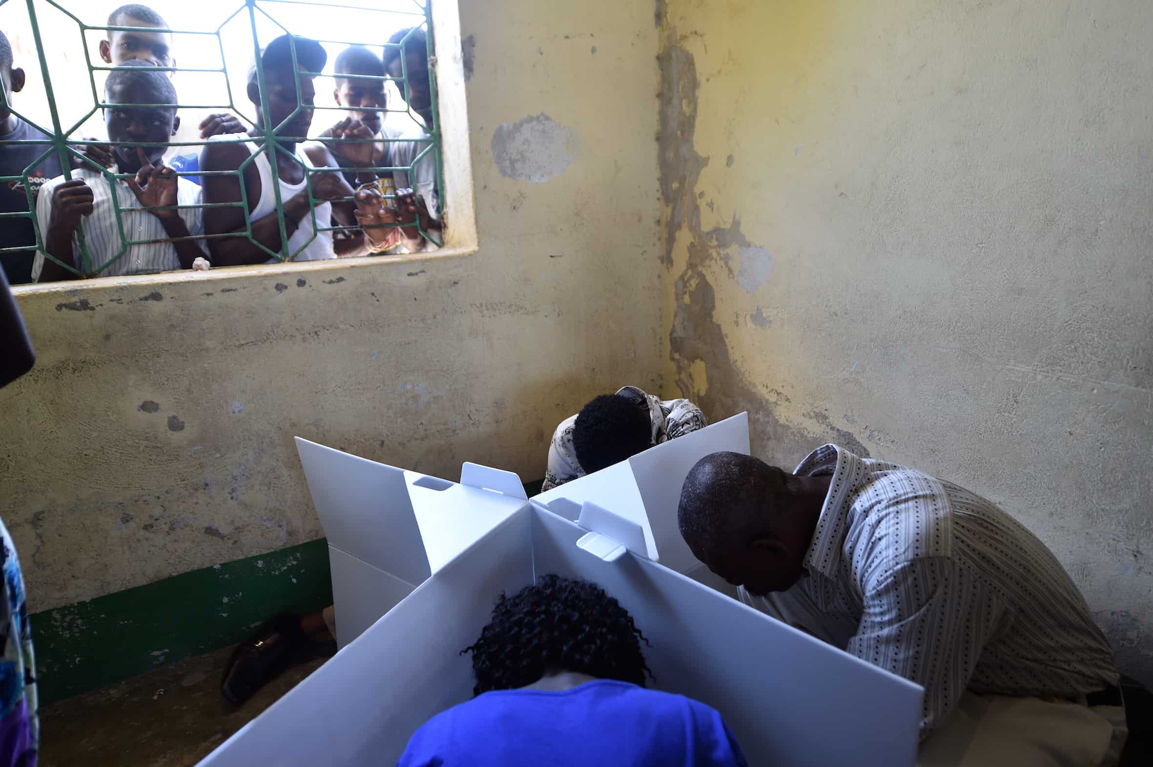 Haitians cast their ballots at a polling station during the Legislative Elections in Port-au-Prince on August 9, 2015.