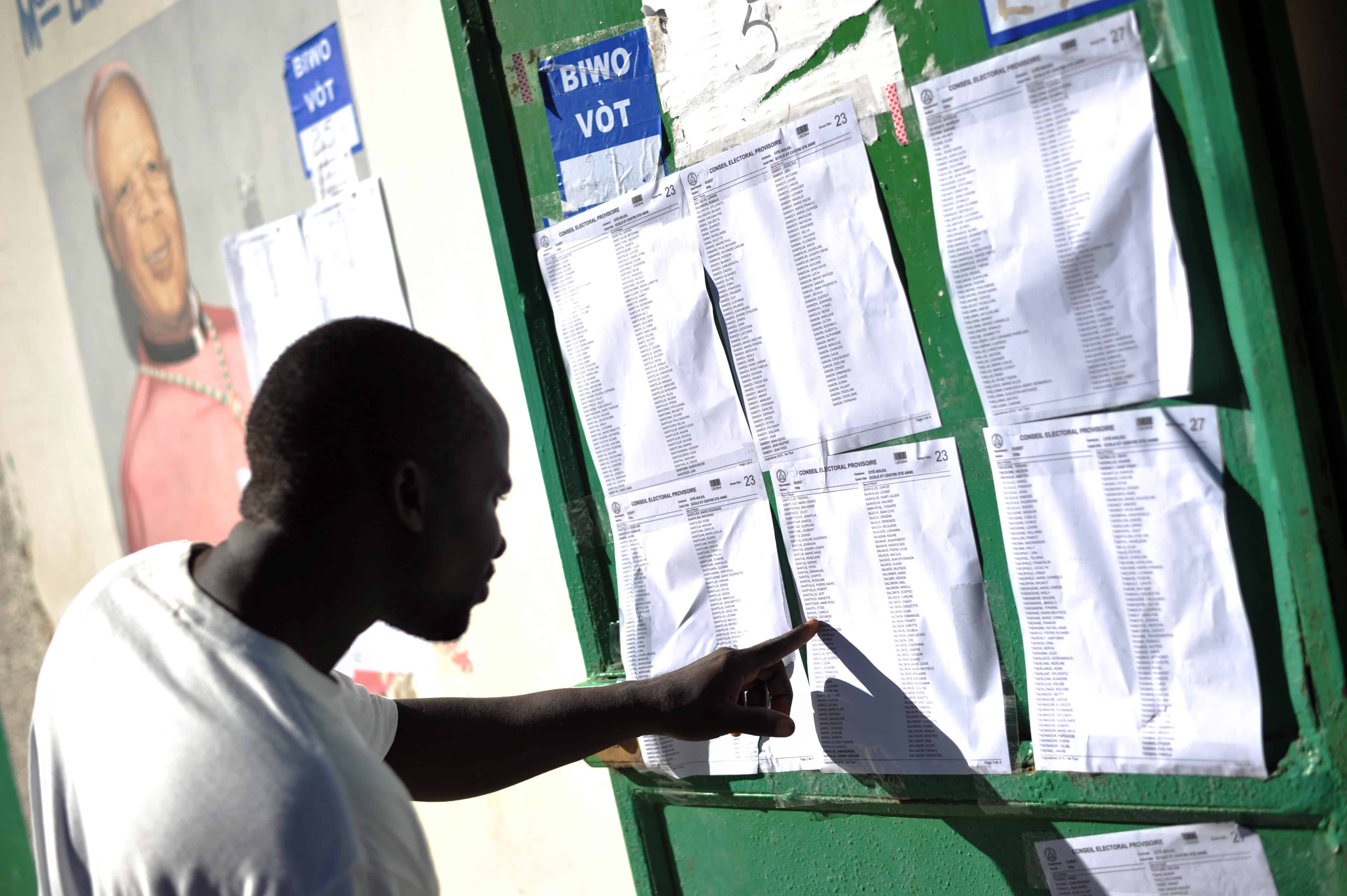 A voter checks a list at a polling station during the legislative elections in Port-au-Prince.