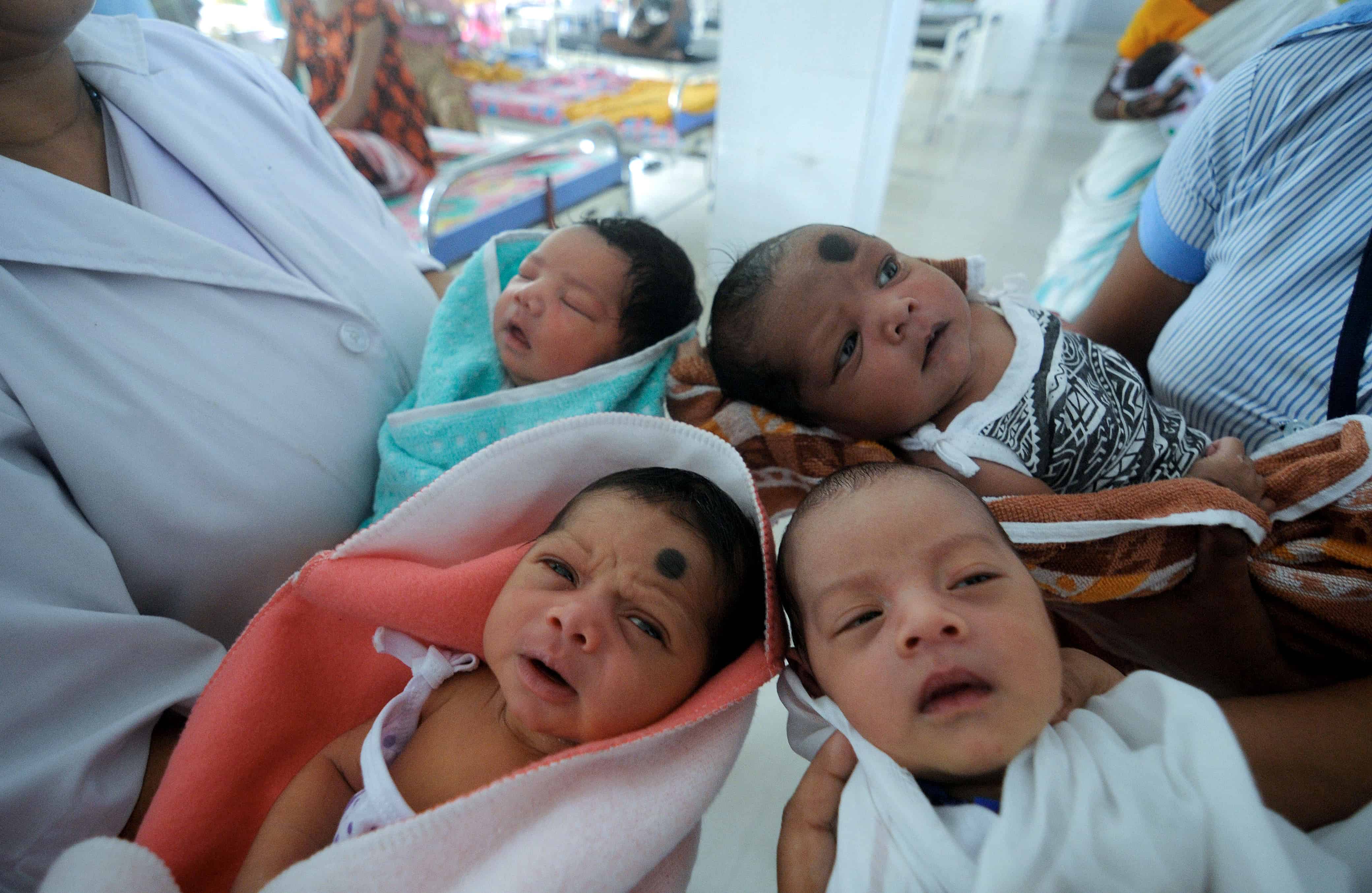Indian nurses care for newly born babies at the maternity ward of a hospital on the eve of World Population Day, in Guwahati.