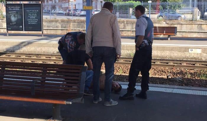 A photo taken by a passenger with a smartphone through the window of a Thalys train shows police detaining a suspect.
