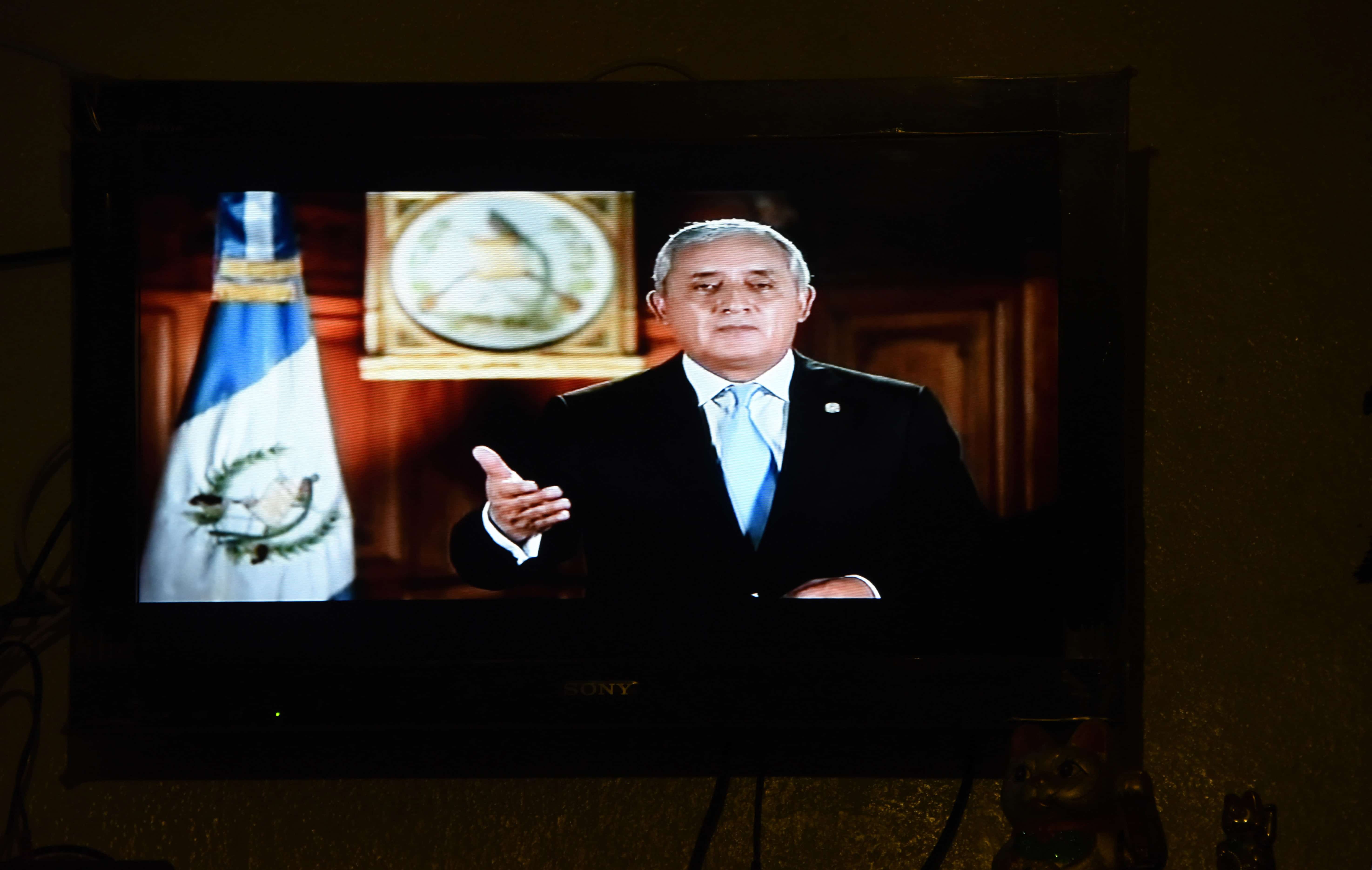 Guatemalan President Otto Pérez Molina's live broadcast is seen at a restaurant in Guatemala City.