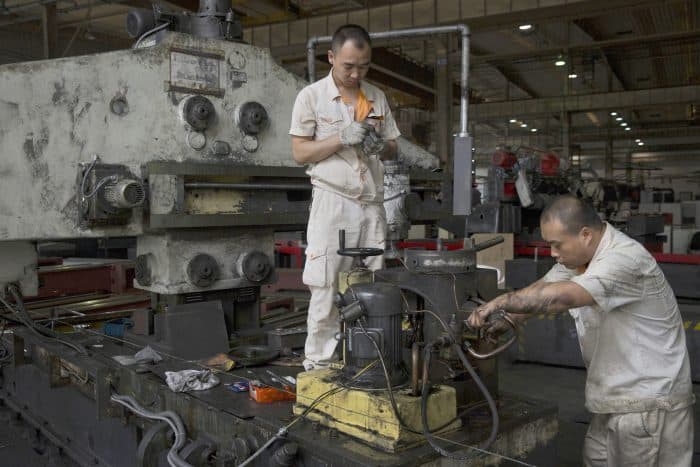 Factory workers are seen working in the Shenyang Machine Tool (Group) Co., Ltd. milling workshop in Shenyang, China on Aug. 19. 