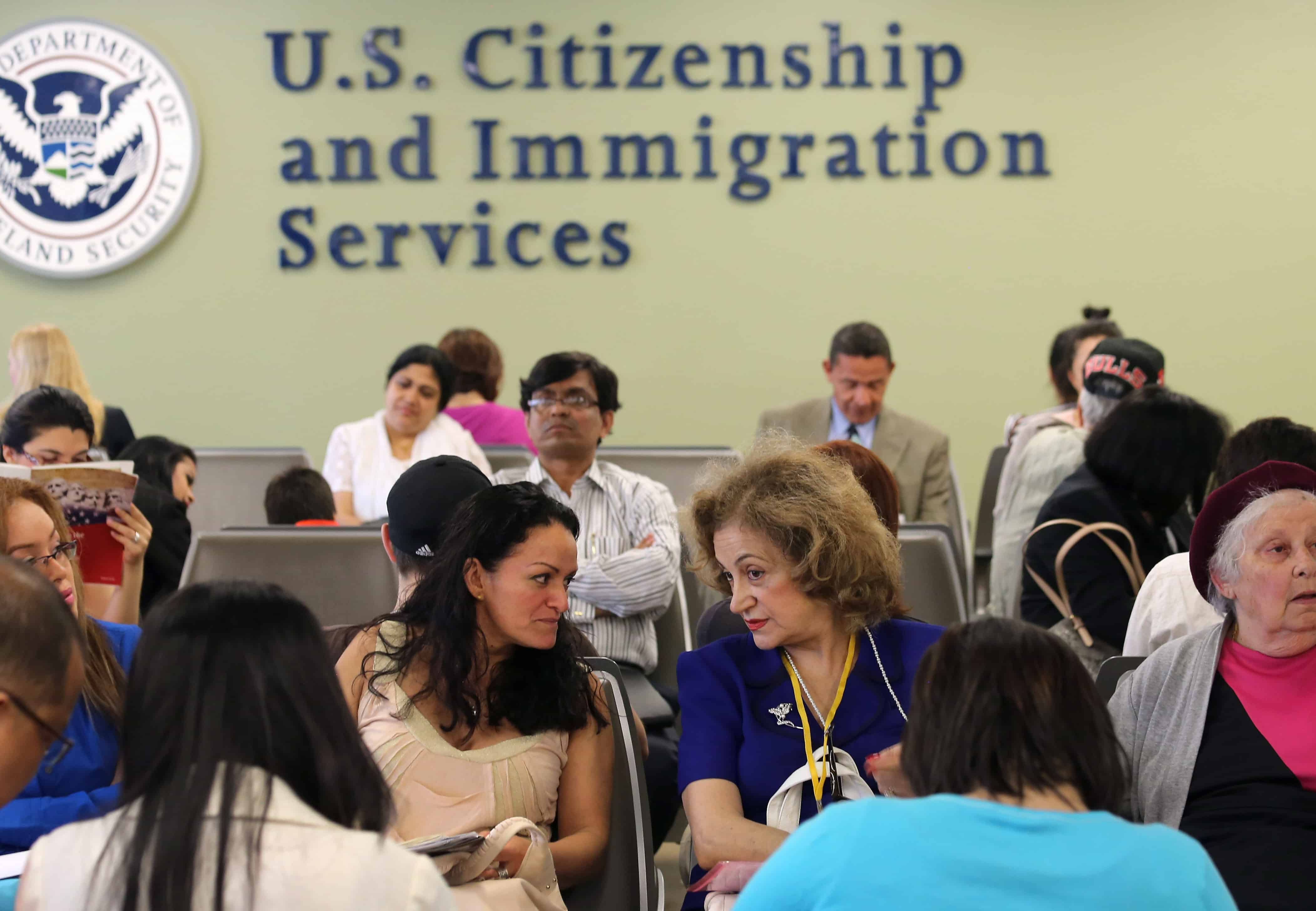 Immigrants await their turn for green card and citizenship interviews at the U.S. Citizenship and Immigration Services office in Queens, NY on May 30, 2013.