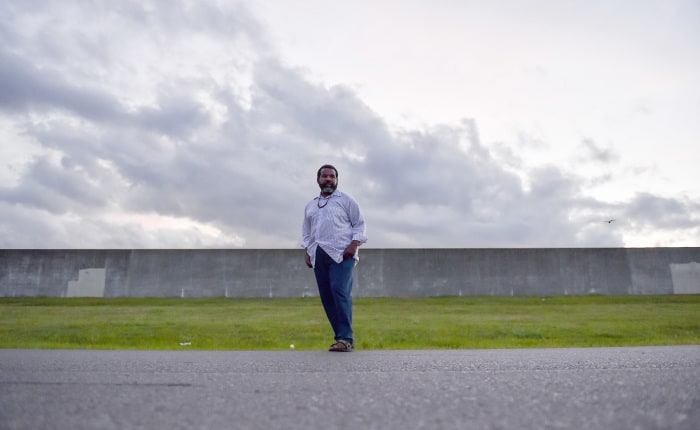 Keith Allen is pictured in front of the levee across from his home. 