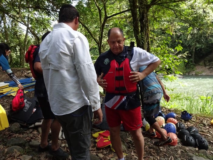 Solís adjusts his life vest in preparation for rafting.