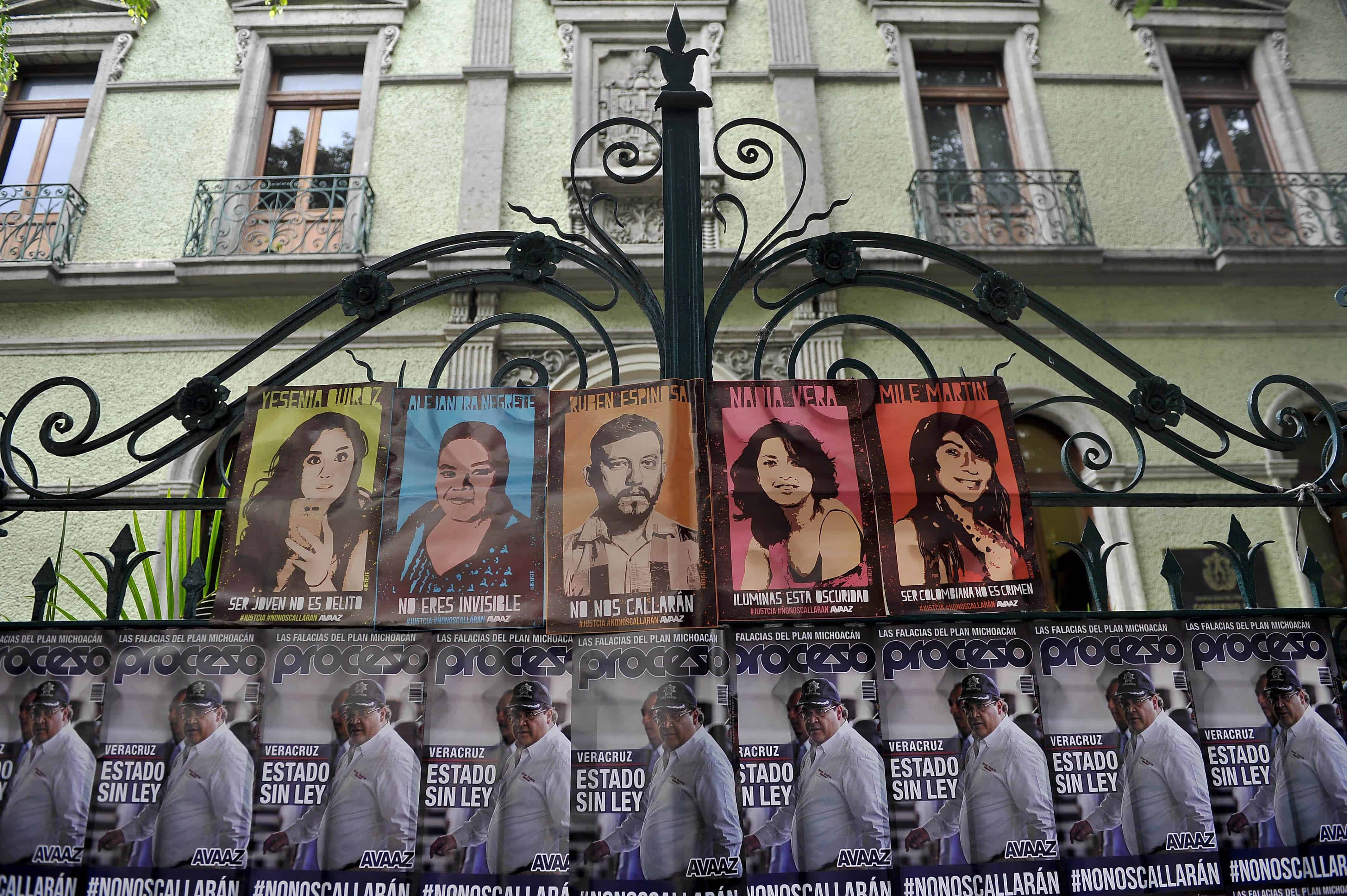 Posters with the image of Veracruz state Governor Javier Duarte (at bottom) and the victims of a horrendous killing hang outside the office of Veracruz state officials in Mexico City on Aug. 31, 2015.