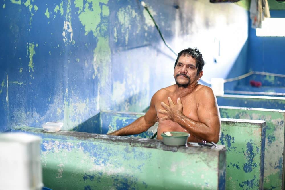 Esteban Villagrá takes a shower in his cell at La Reforma prison. He was charged for homicide eight years ago and has 17 years left on his sentence.