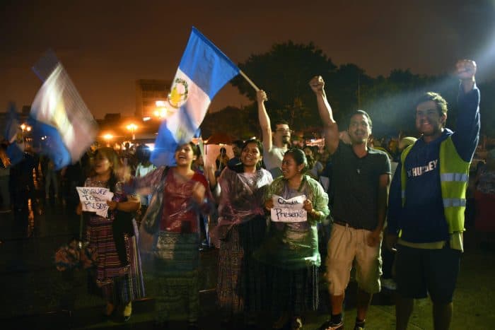 Guatemalans celebrate after Congress voted unanimously to strip then-President Otto Pérez Molina of his immunity.