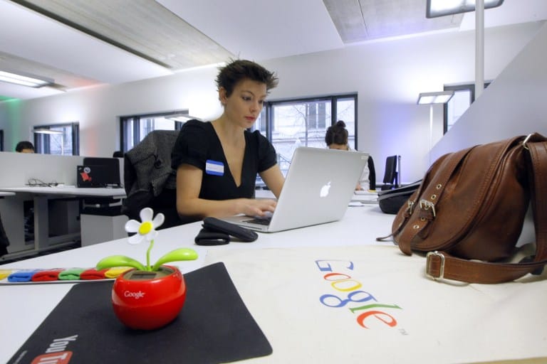 Employees work in the Google France new offices on December 6, 2011 in Paris before its inauguration. AFP PHOTO POOL JACQUES BRINON