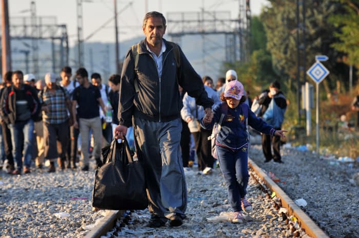 Refugees wait to cross the Greece-Macedonia border.