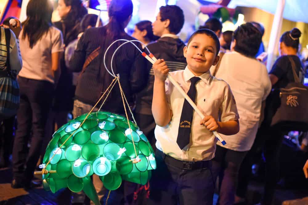 A close-up of a child's hand-made lantern, showcasing vibrant colors and creative designs, symbolizing Costa Rica's independence and freedom.