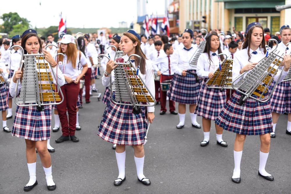 Students performing a synchronized marching routine during Costa Rica's Independence Day celebrations.