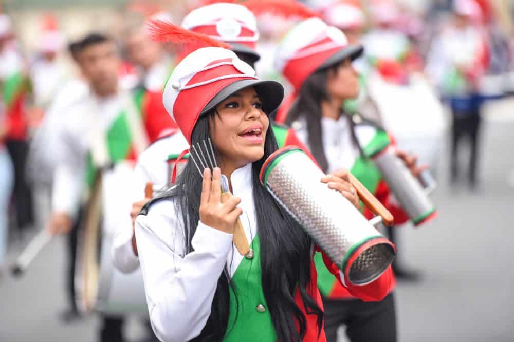 A traditional dancer mid-performance, with a colorful dress twirling during the parade