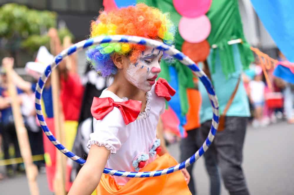 A child in colorful, traditional Costa Rican costumes, dancing during the Independence Day festivities.