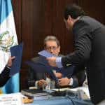 Otto Pérez Molina's lawyer, César Calderón, right, delivers a report on the corruption scandal to a congressional investigative committee.