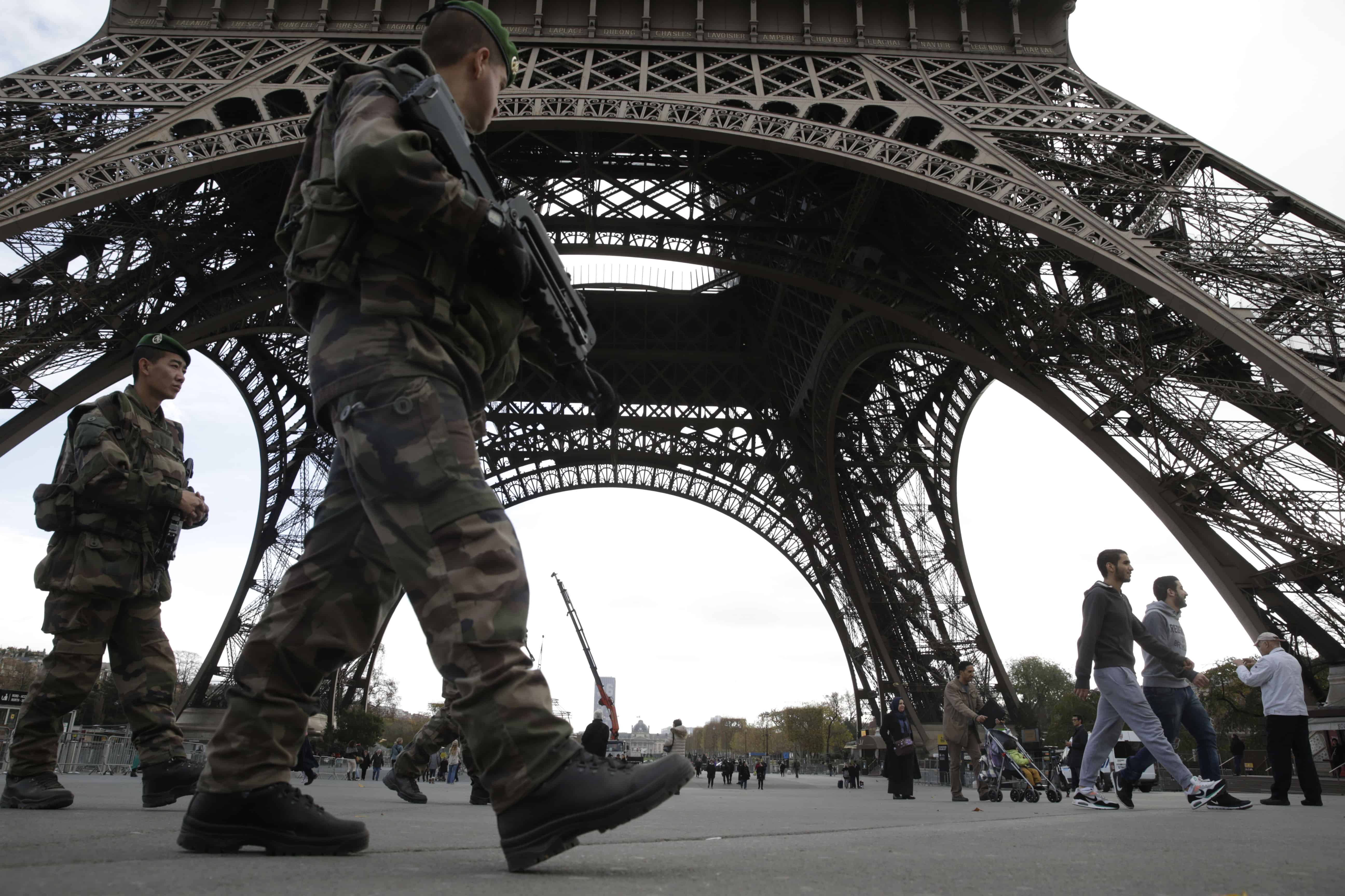 Soldiers patrol at the foot of the Eiffel Tower in Paris