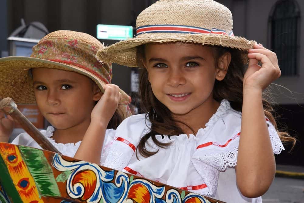 Crowds gather to watch the largest oxcart parade in Costa Rica as oxen and boyeros march through San José."
