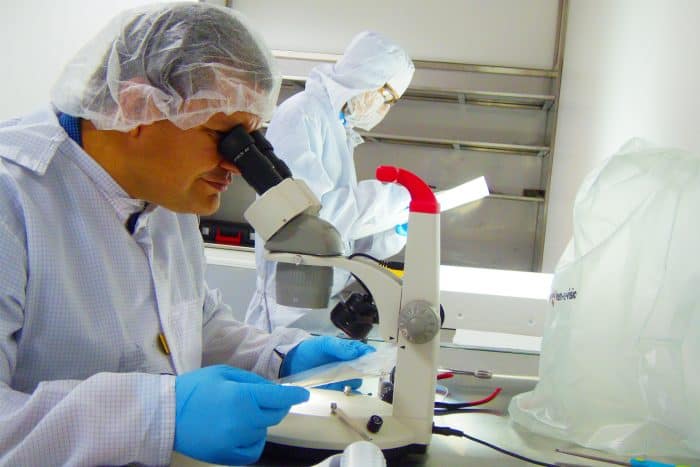 Costa Rica man at microscope for Life Sciences