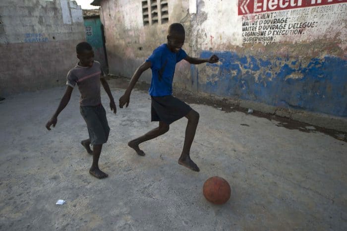 Haiti, boys playing football in Cite Soleil