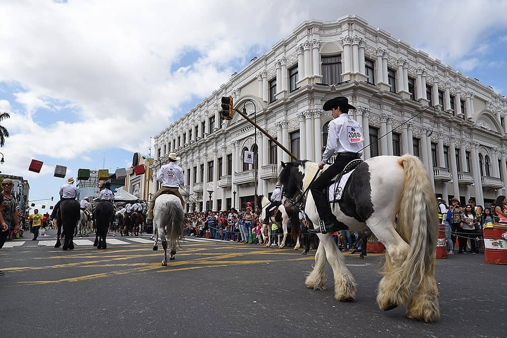 Spectators in cowboy hats and boots enjoying the Costa Rica tope parade festivities.