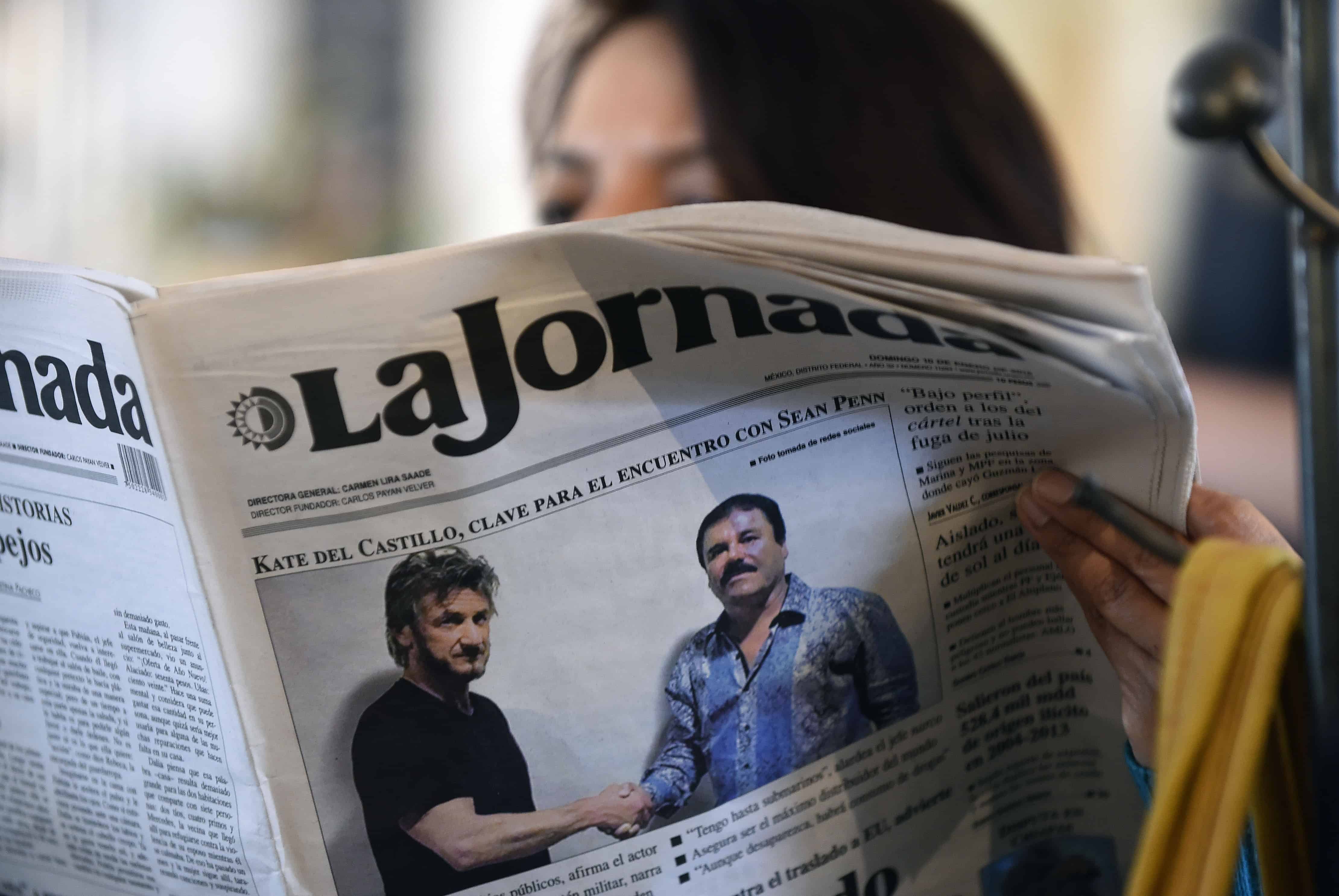 A woman reads La Jornada newspaper in Mexico City, on Jan. 10, 2016, showing a photo of drug lord Joaquín Guzmán, aka 