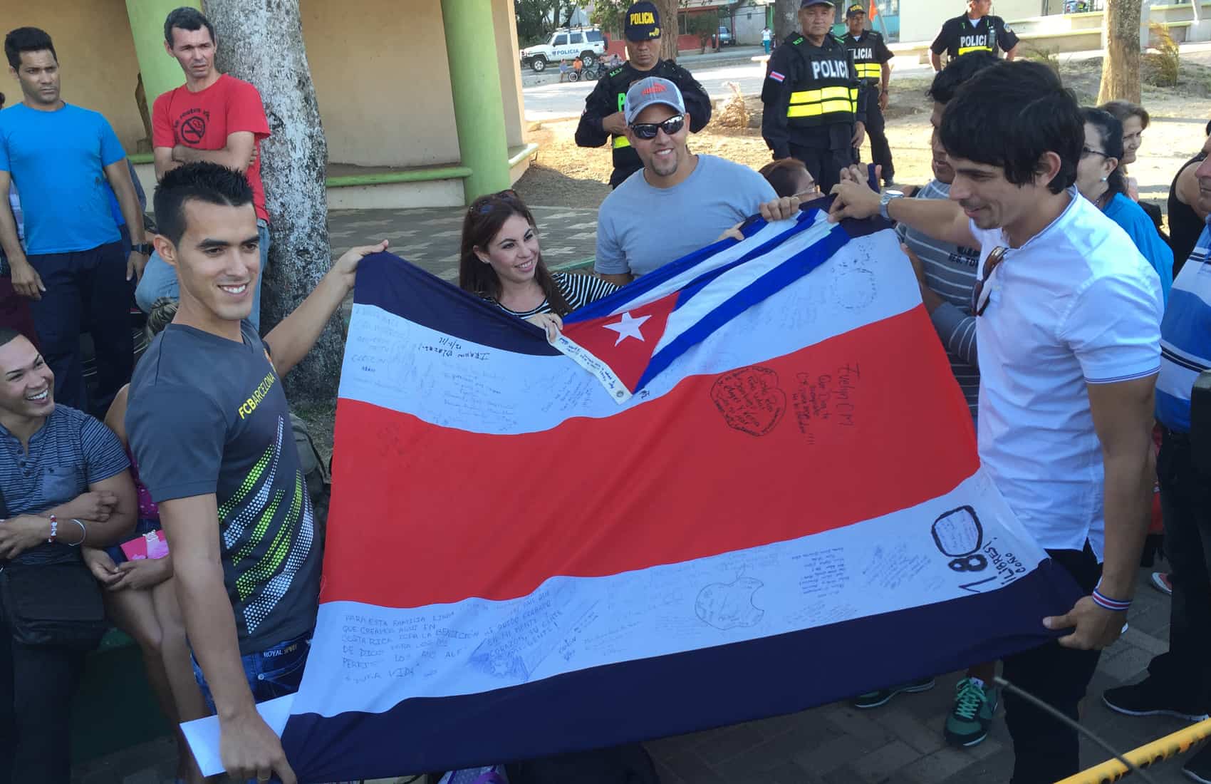 Cuban migrants hold flags from Cuba and Costa Rica