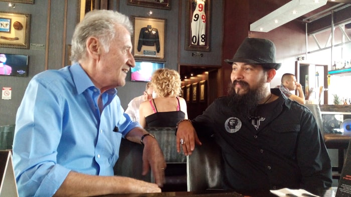 Dave Scott, 73, leader of the Blind Pig Blues Band, talk to Fausto Solano, general manager of the Hard Rock Café, San José, Costa Rica.