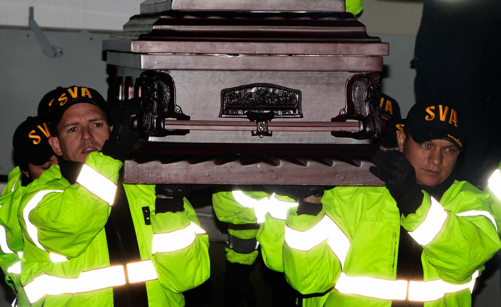 Costa Rican Air Surveillance Service officers escort a body