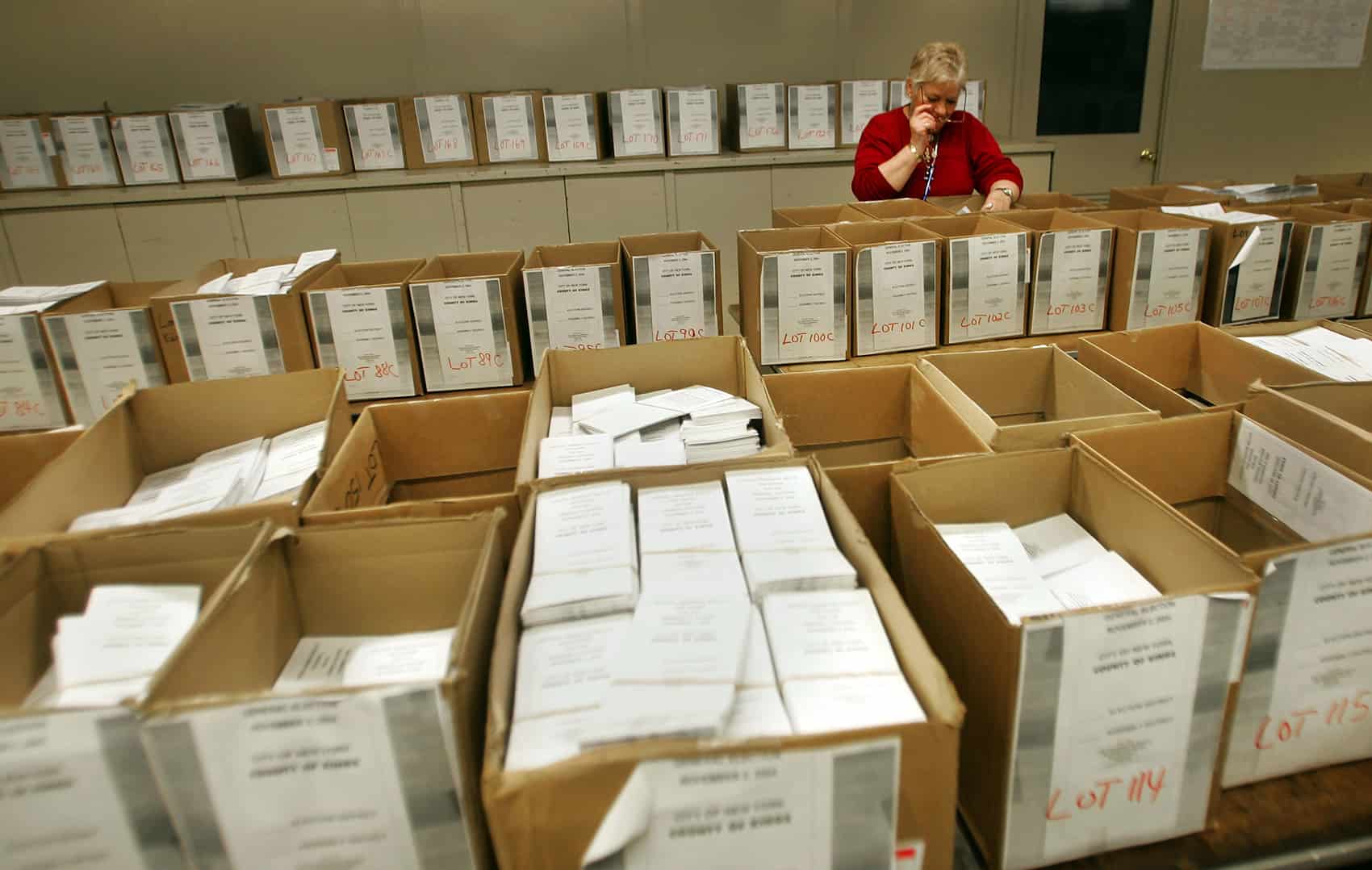 Expat voting: A poll worker looks over thousands of absentee ballots