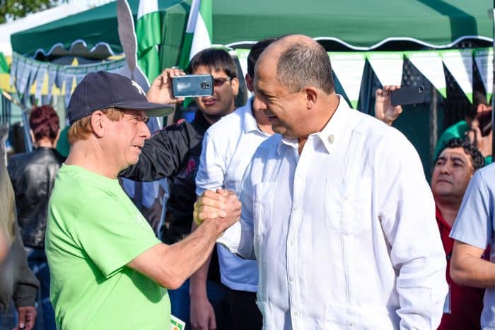 President Luis Guillermo Solís greets a National Liberation Party follower upon his arrival at the Mexico school in Barrio Aranjuez, San José. Municipal elections.