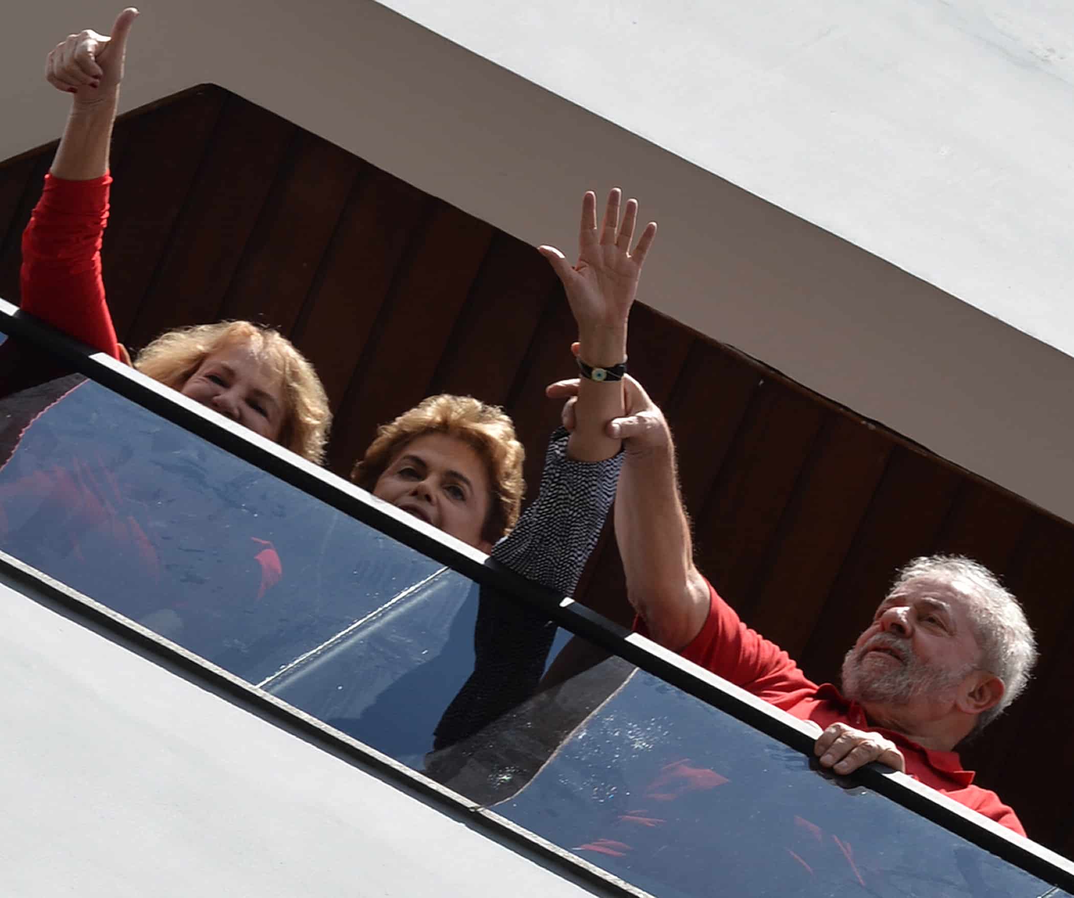 Former Brazilian President Luiz Inacio Lula da Silva, right, current President Dilma Rousseff, center, and Lula's wife Marisa Leticia