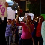 Sexual harassment protester yells in a megaphone