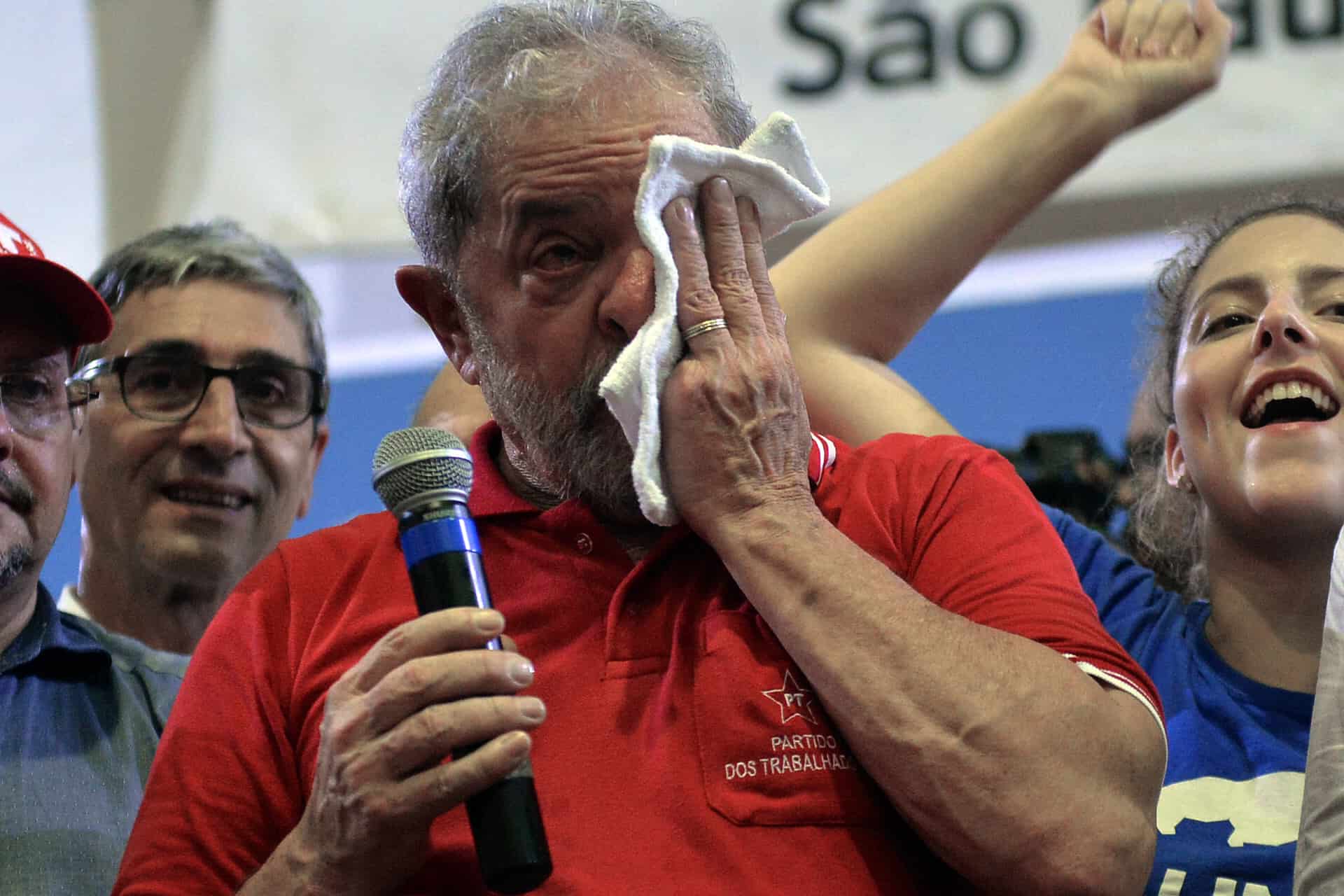 Brazil's former President Luiz Inacio Lula da Silva wipes away tears.