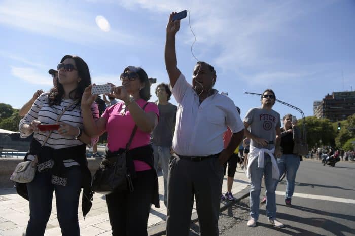 Bystanders watch Obama in Argentina