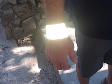 The same wristband lights up when photographed with a flash.