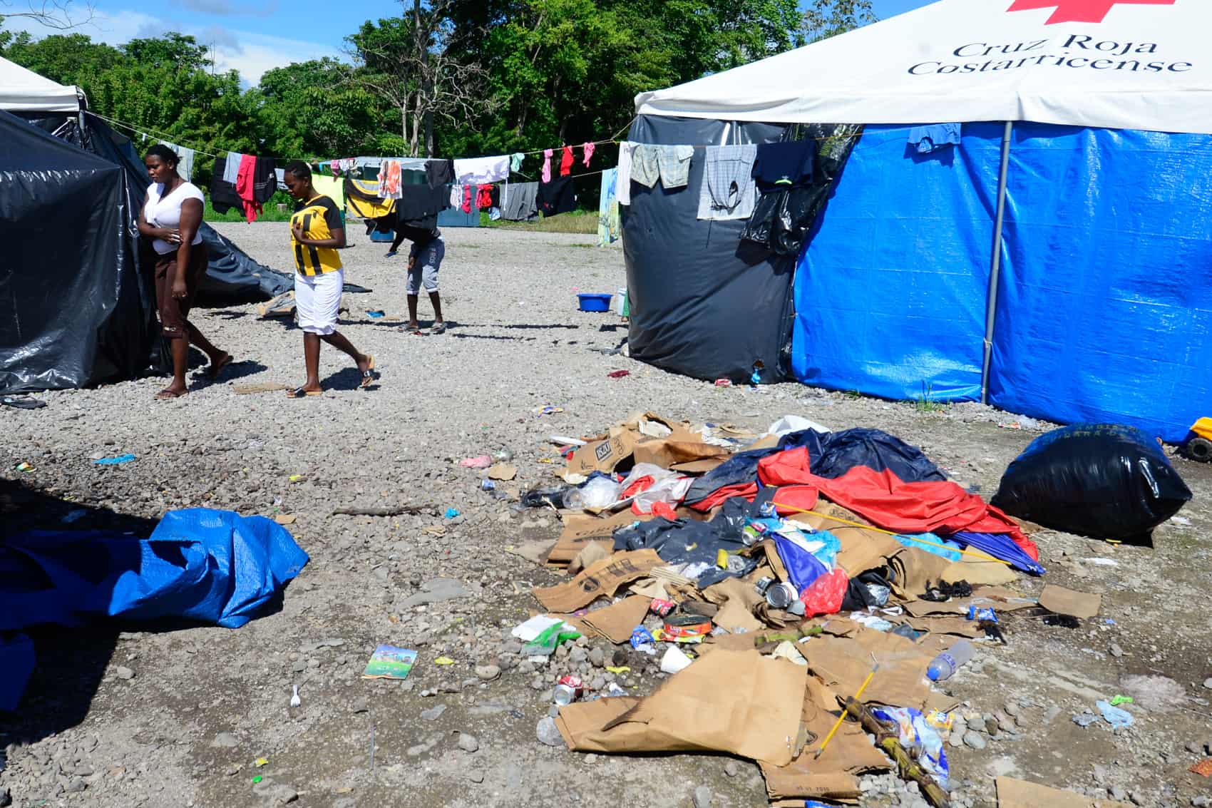 A pile of trash outside of tents.